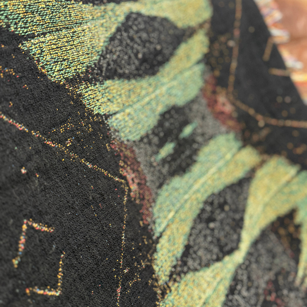 Close-up of a textured fabric with green and black patterns