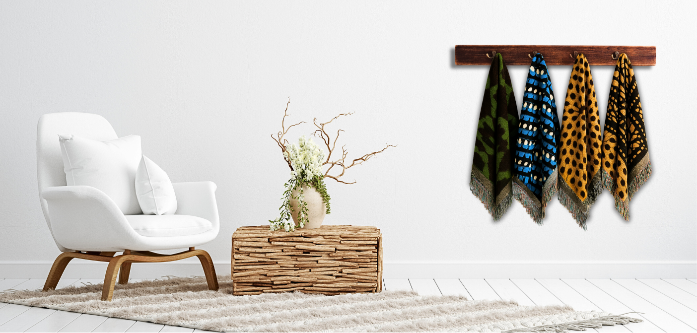 Modern living room with a white armchair, woven basket, and wall-mounted shelf with patterned woven 100% cotton throw blankets with fringed edges.